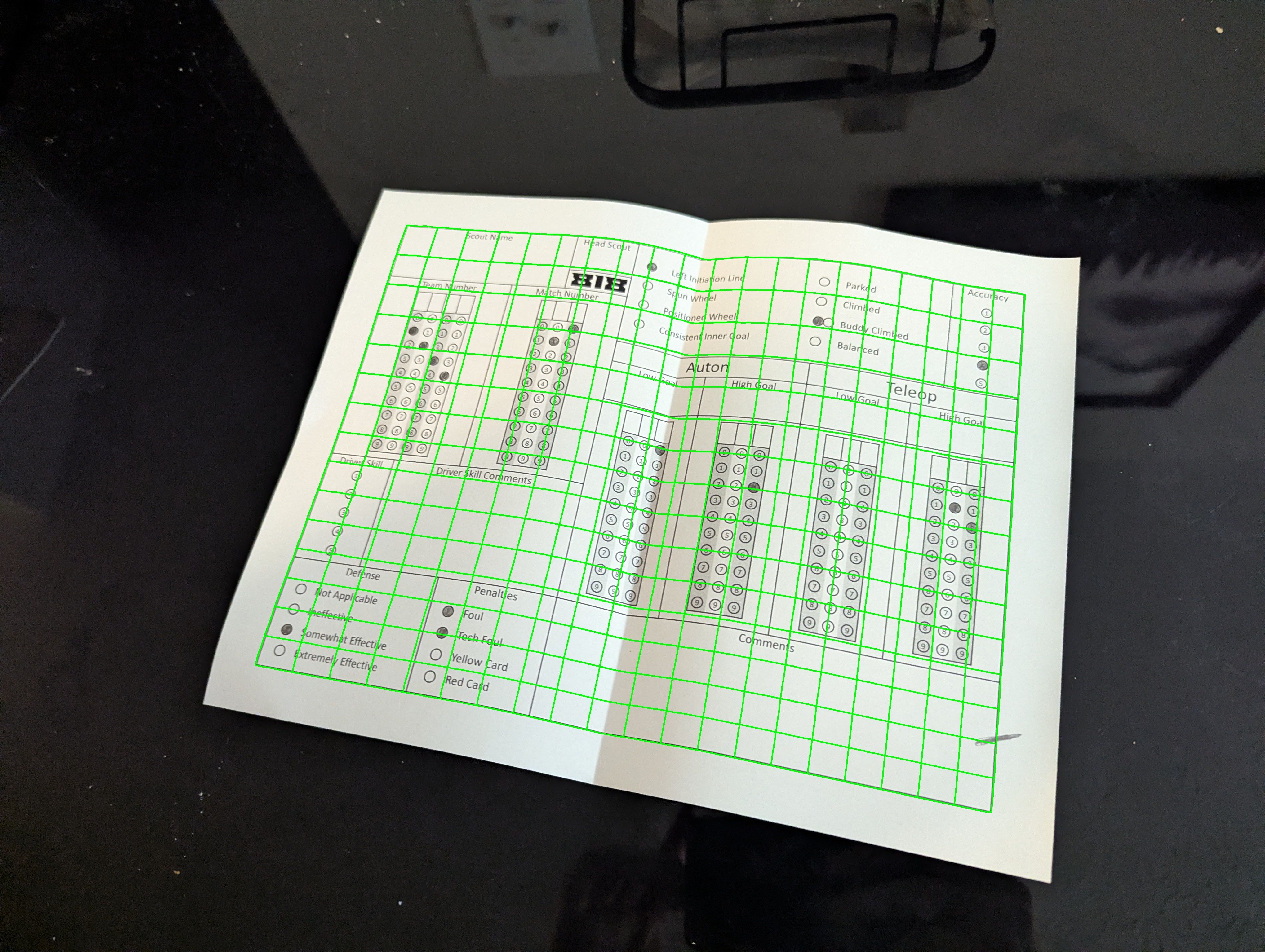 Gray image with grid overlaid to follow the curve of the paper